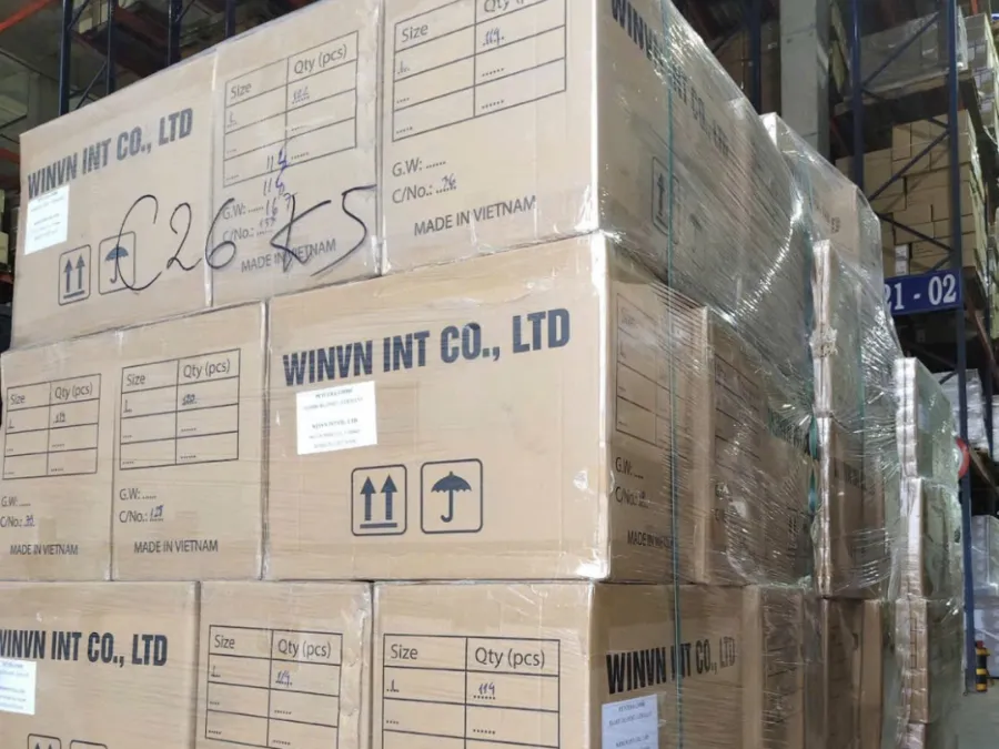 Pallet of WINVN INT cartons wrapped and strapped, shipping mark written on the film