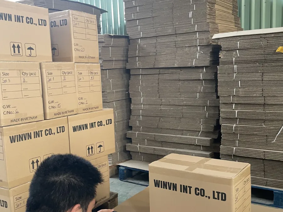 Staff member photographing carton markings for the shipment record