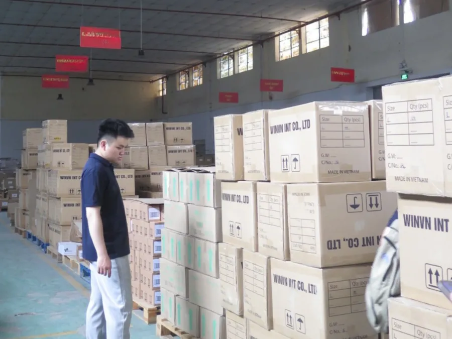 Aisle of the WINVN INT warehouse with stacked cartons on both sides